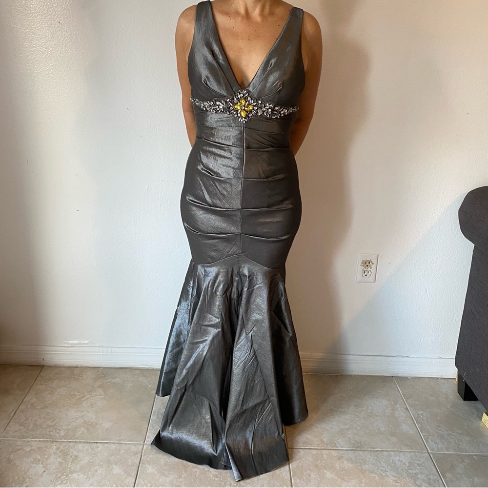 Mermaid style evening gown with V shaped neckline and beaded belt.